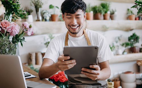 Man using tablet at flower shop