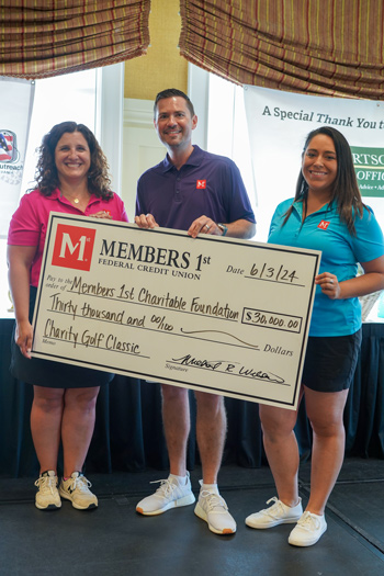 Members 1st CEO and Associate Presenting Check to Members 1st Charitable Foundation
