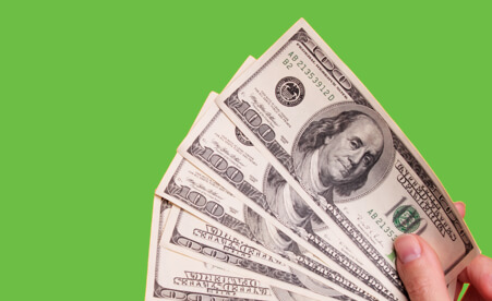 Image containing hundred dollar bills fanned out