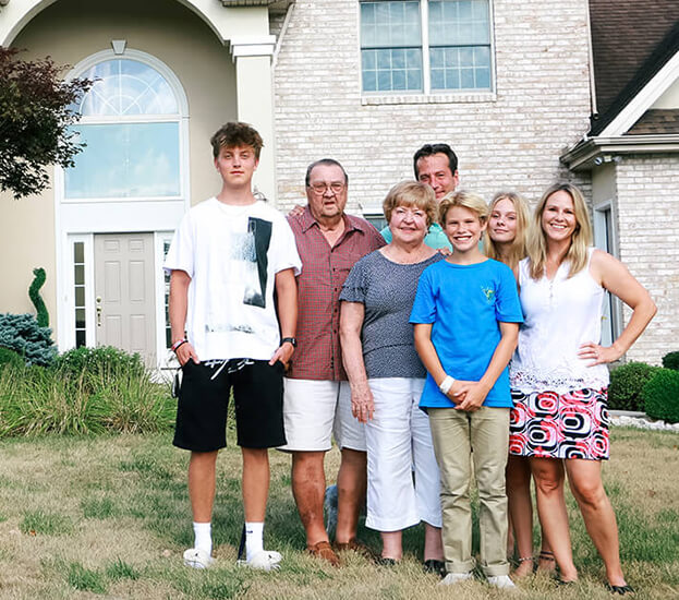 photo of Christina and family in front of their house