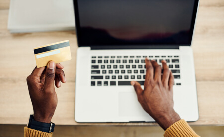 Image containing a blank credit card and a laptop computer