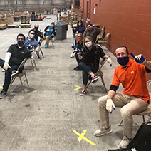 A group of people sitting in chairs at a volunteer event