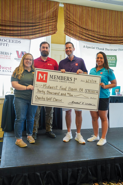 Members 1st CEO and Associate Presenting Check to Midwest Food Bank PA